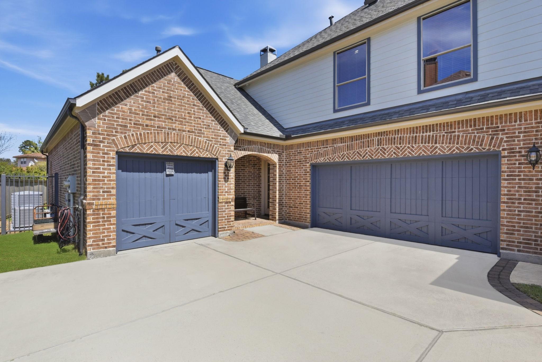 Image 2: This photo shows a modern three-car garage with bl