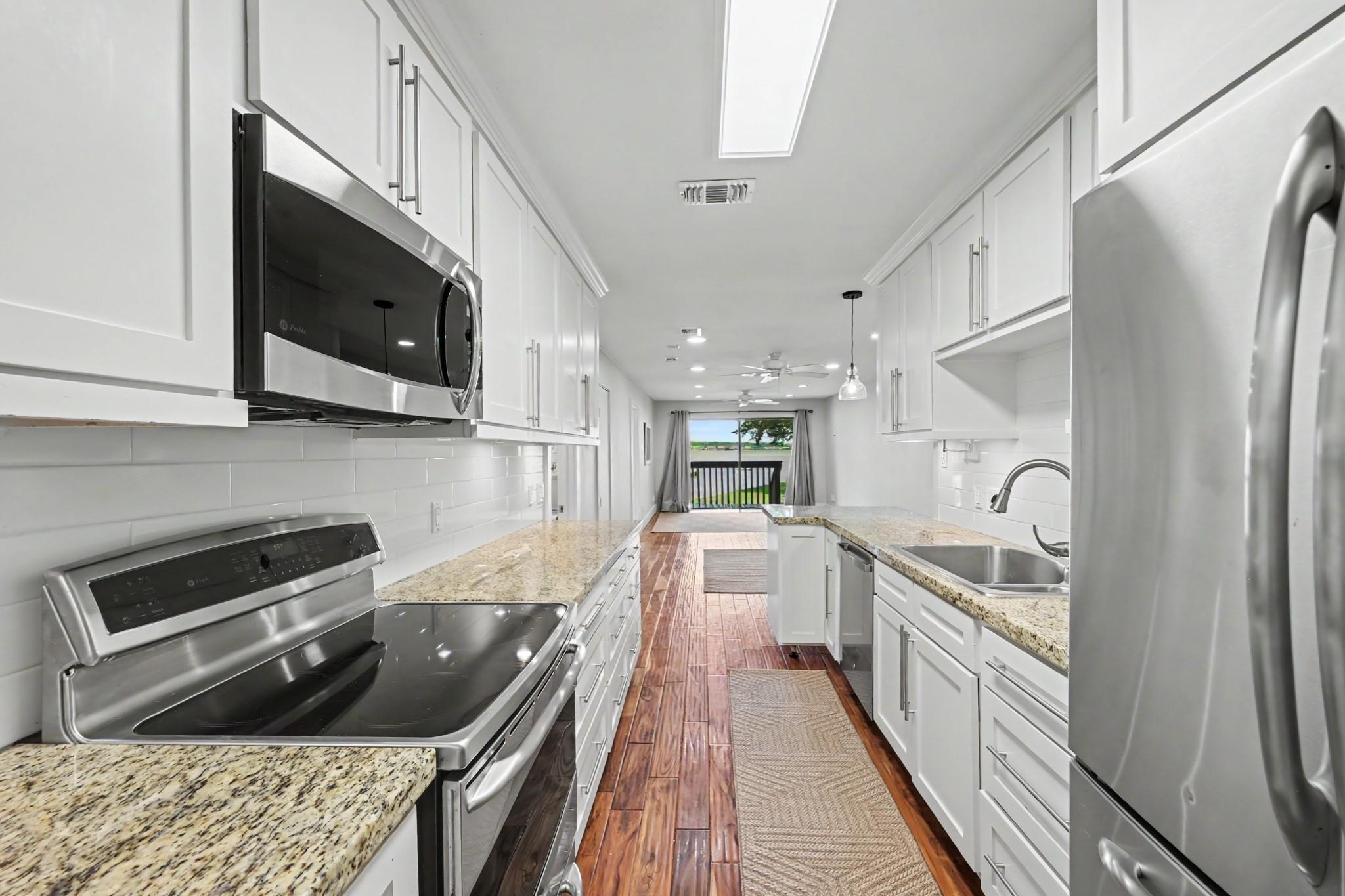 Image 2: Modern kitchen with sleek stainless steel applianc