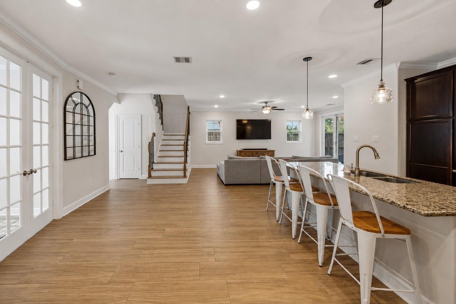 Image 4: This home has wide plank tile flooring, a kitchen