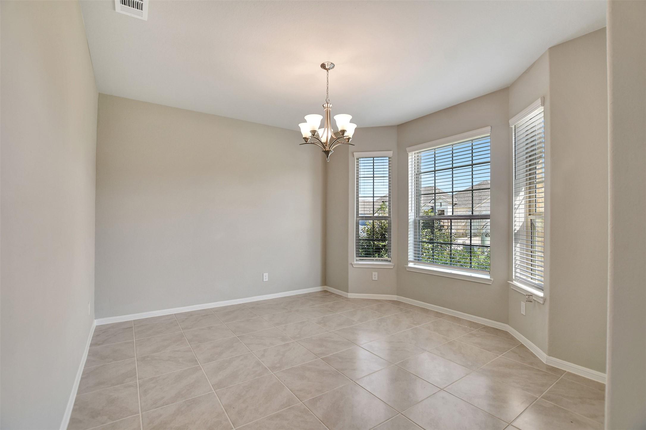 Image 4: Formal dining room looks out to the front yard