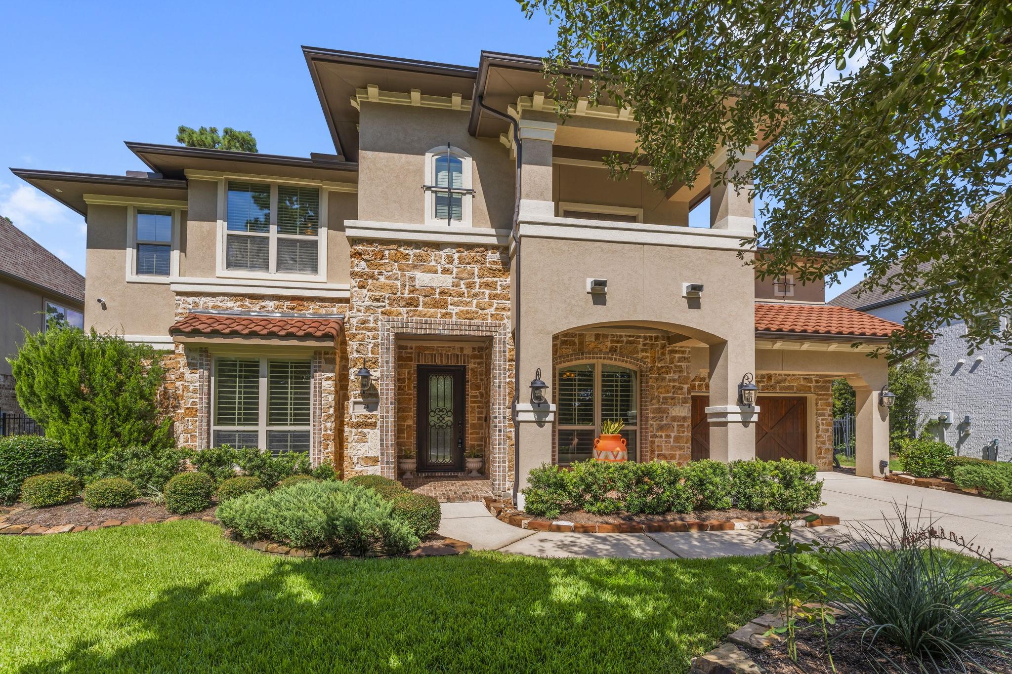 Image 3: Elegant exterior with 3-car garage and manicured l