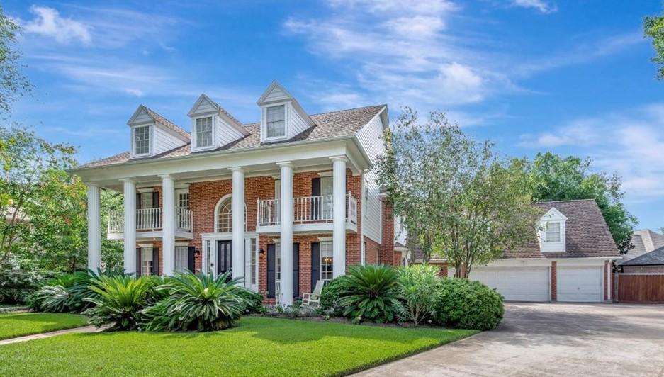 Image 2: Long, wide driveway to three-car garage with works