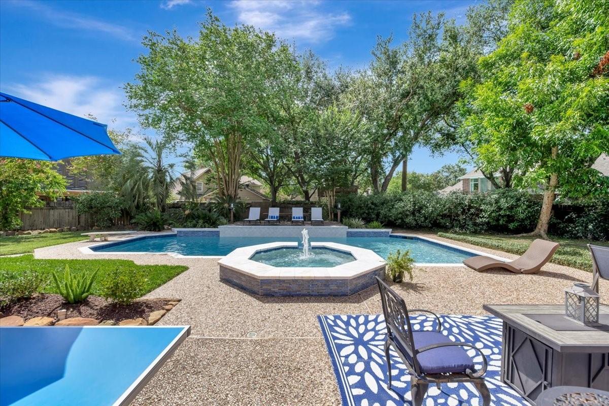 Image 3: The view of the backyard (heated) pool and spa fro