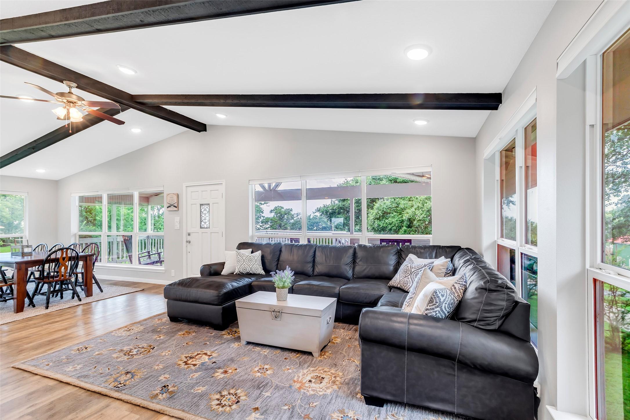 Image 2: Spacious living room with large windows offering a