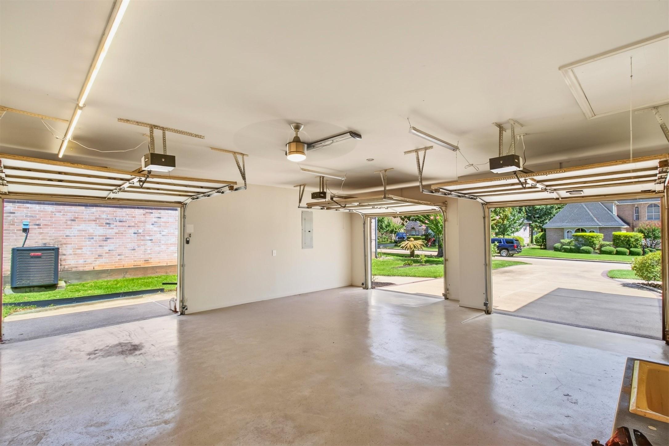 Image 3: Plenty of garage access with three doors.