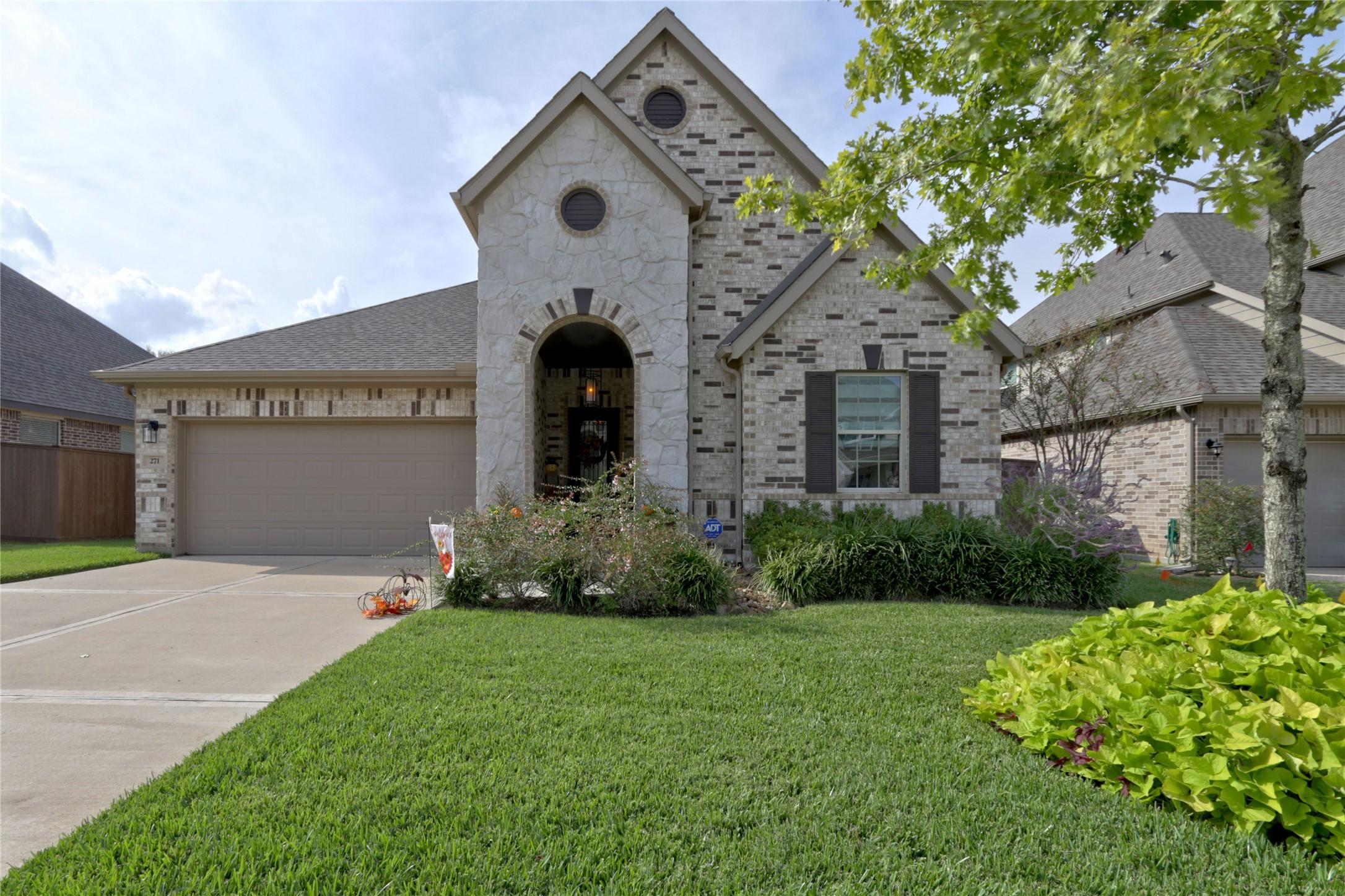 Image 2: Charming single-story home with a stone and brick