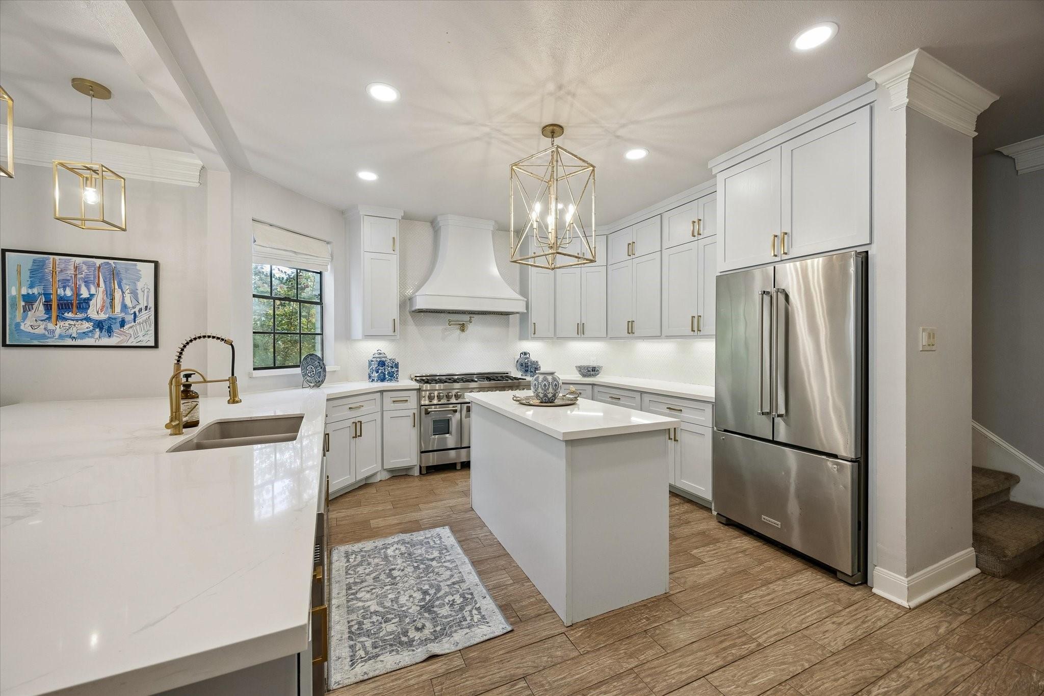 Image 2: Beautifully updated kitchen with a center island,