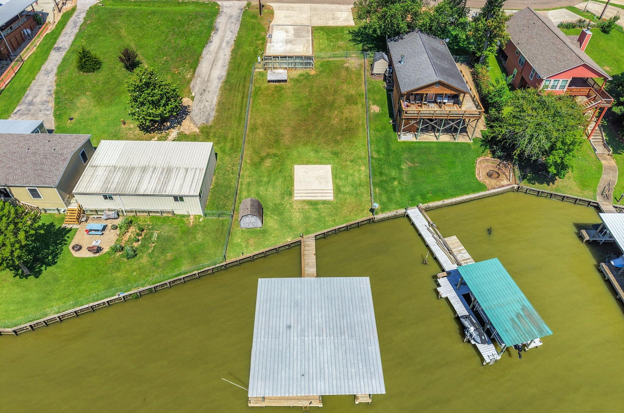 Image 3: The lot is cleared with concrete RV pad, parking,
