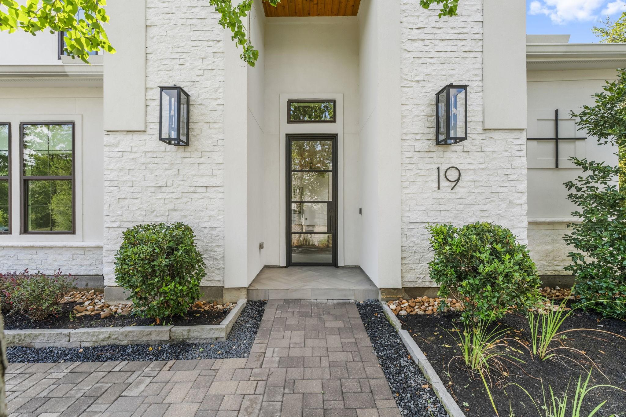 Image 4: Inviting stacked stone and stucco entrance
