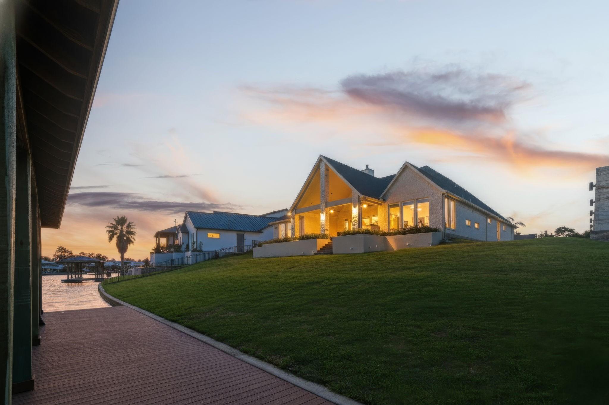 Image 4: The home glows at sunset, showcasing its inviting