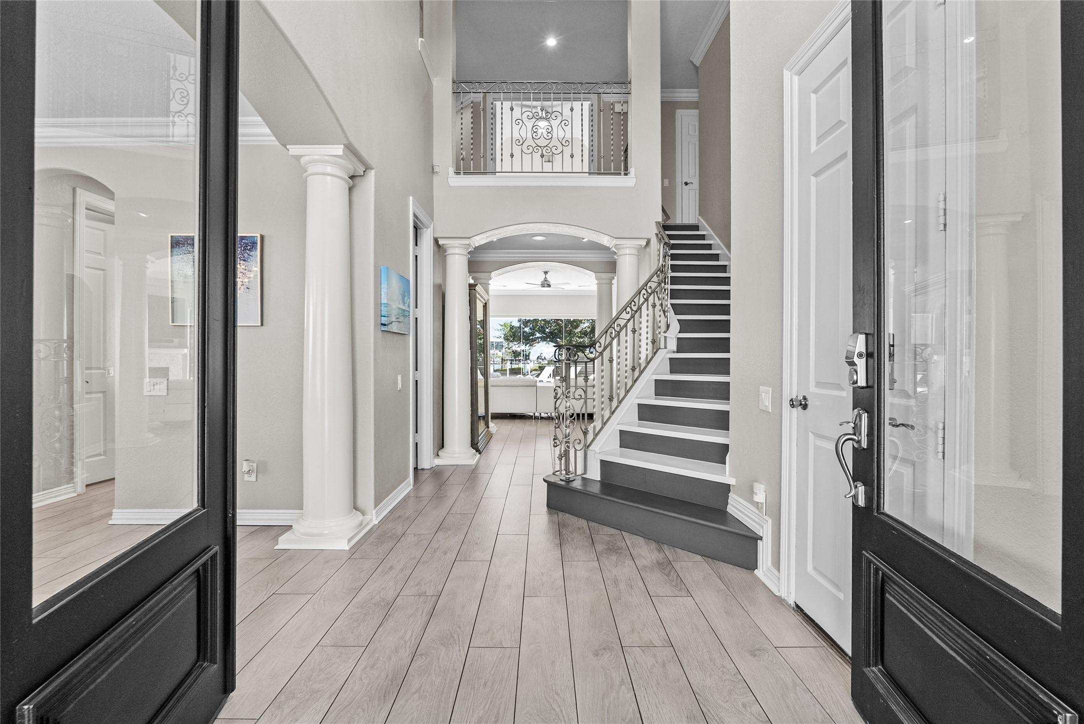 Image 3: Soaring ceilings, elegant staircase, and a direct