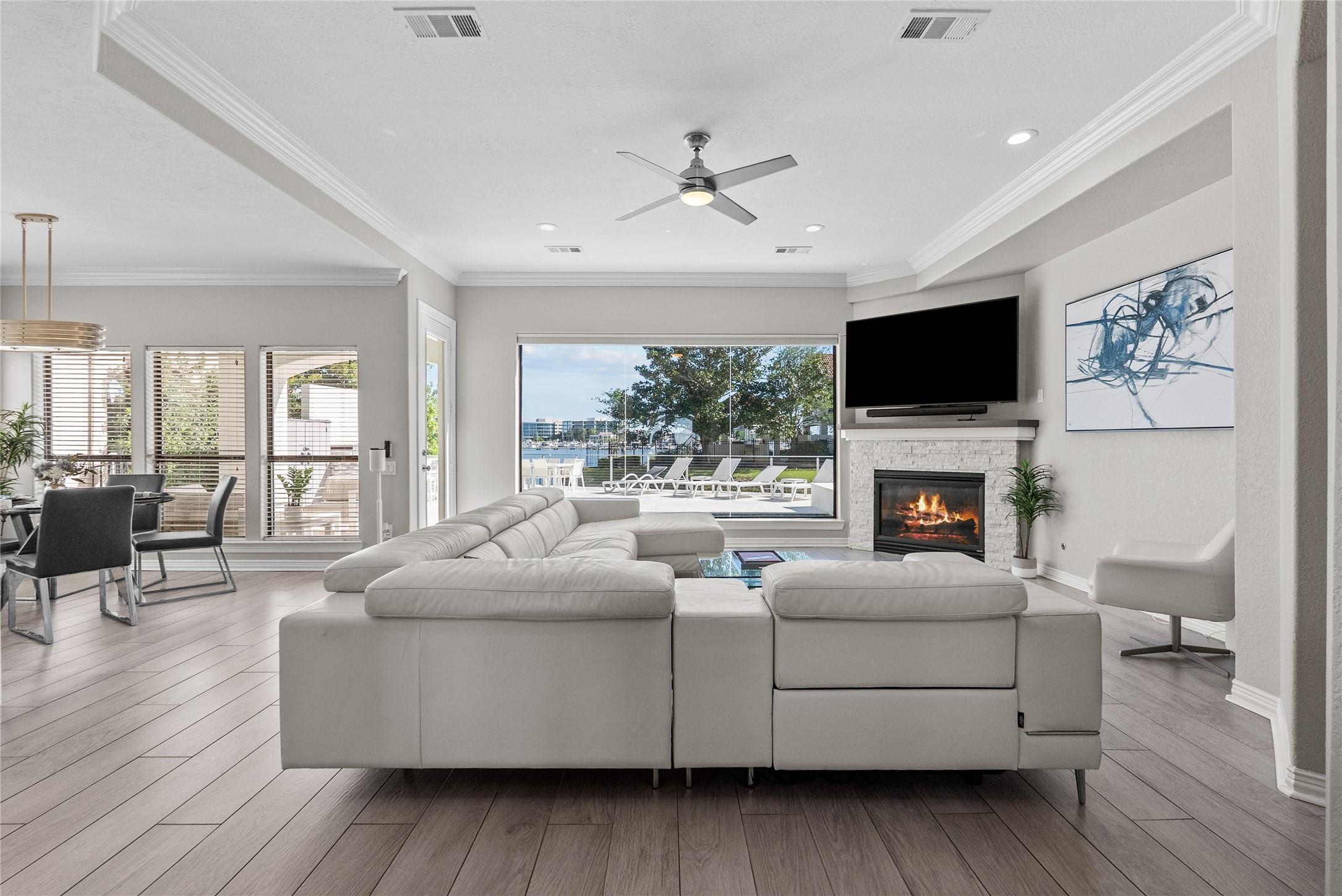 Image 4: Expansive windows flood the open-concept living ar