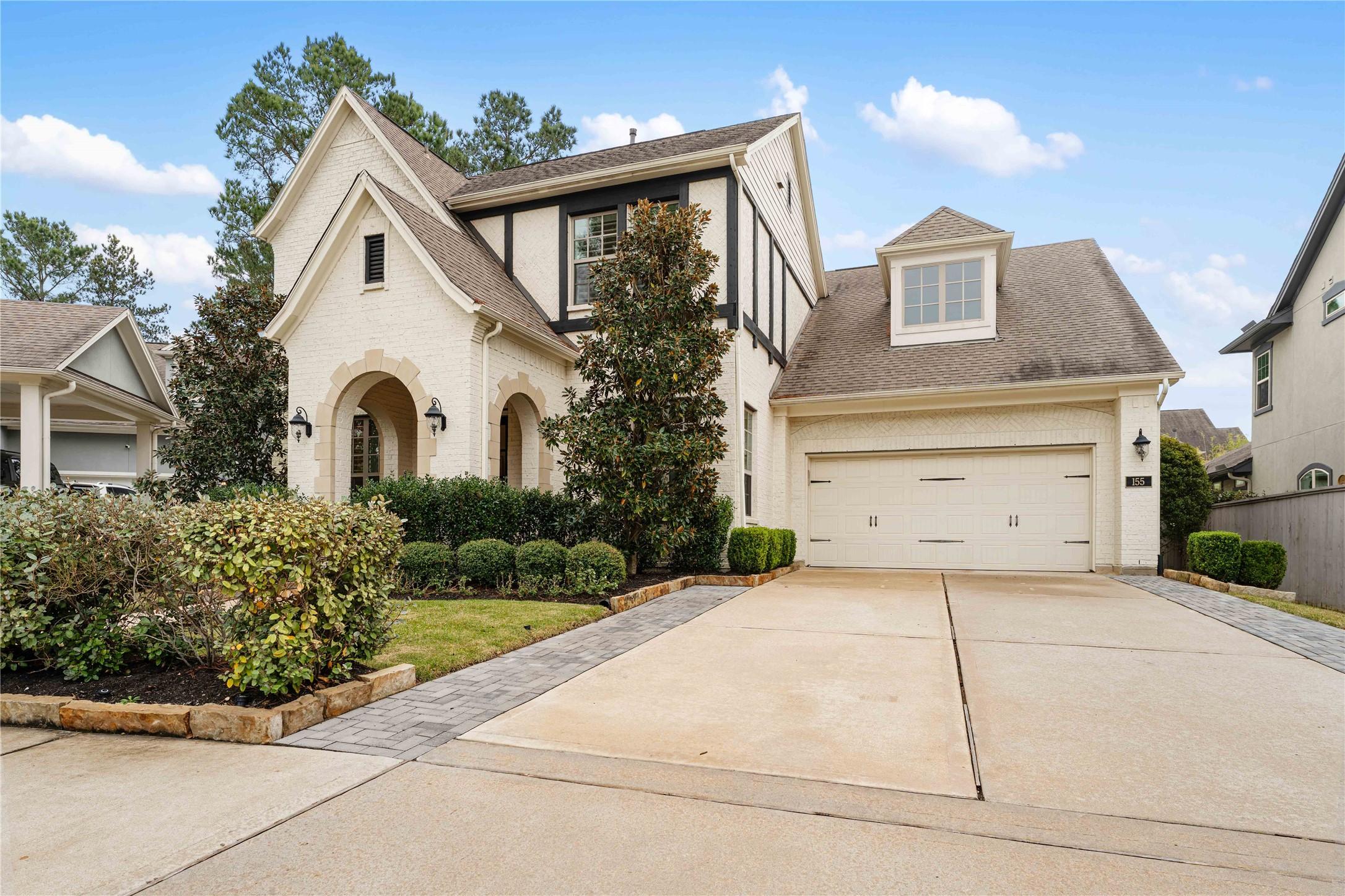 Image 2: This charming two-story home features a classic br