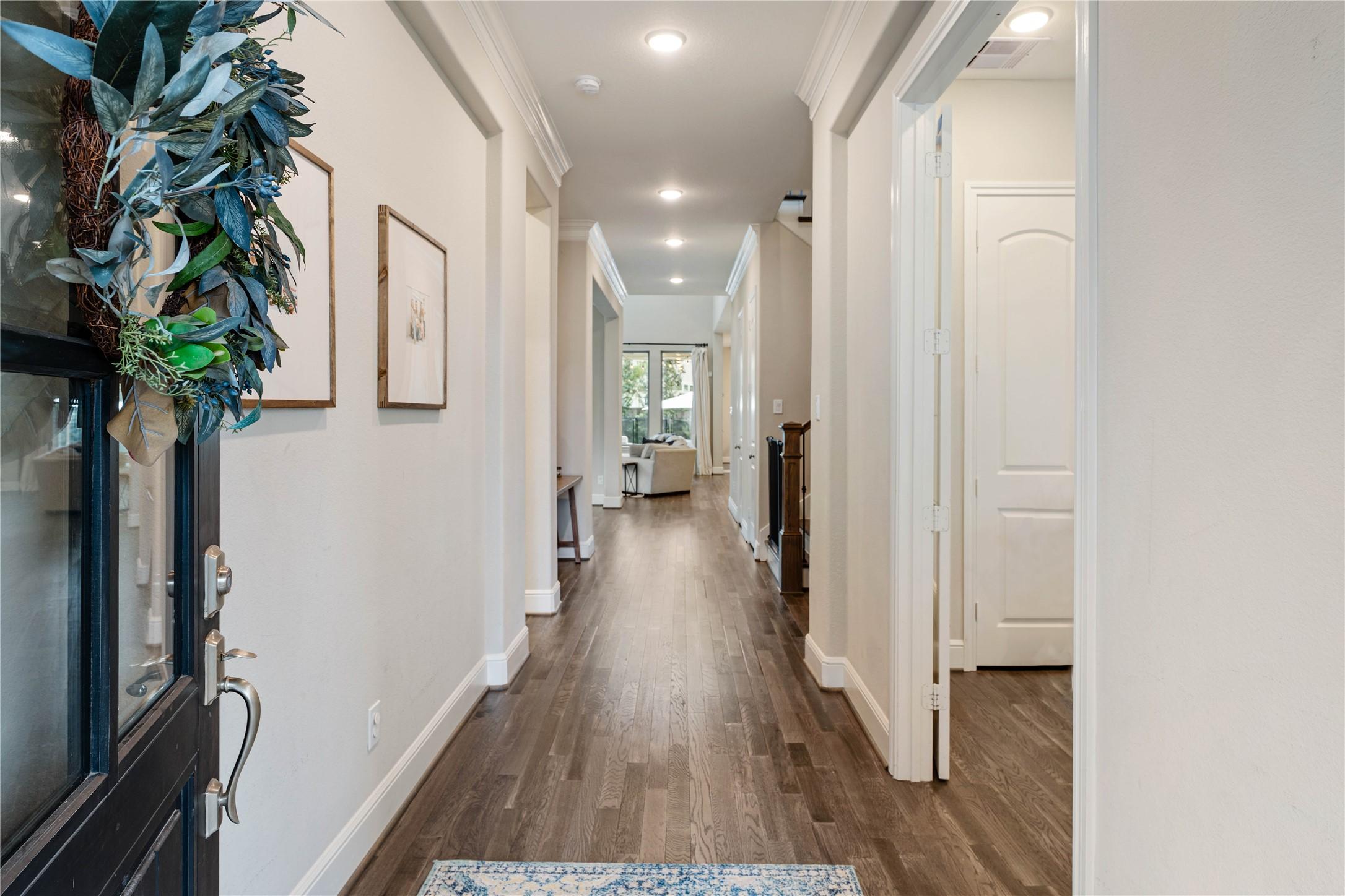 Image 3: Gleaming hardwood floors and neutral walls in the