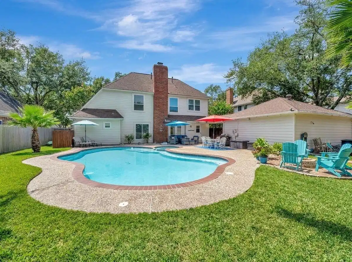 Image 1: Charming backyard oasis featuring a sparkling pool