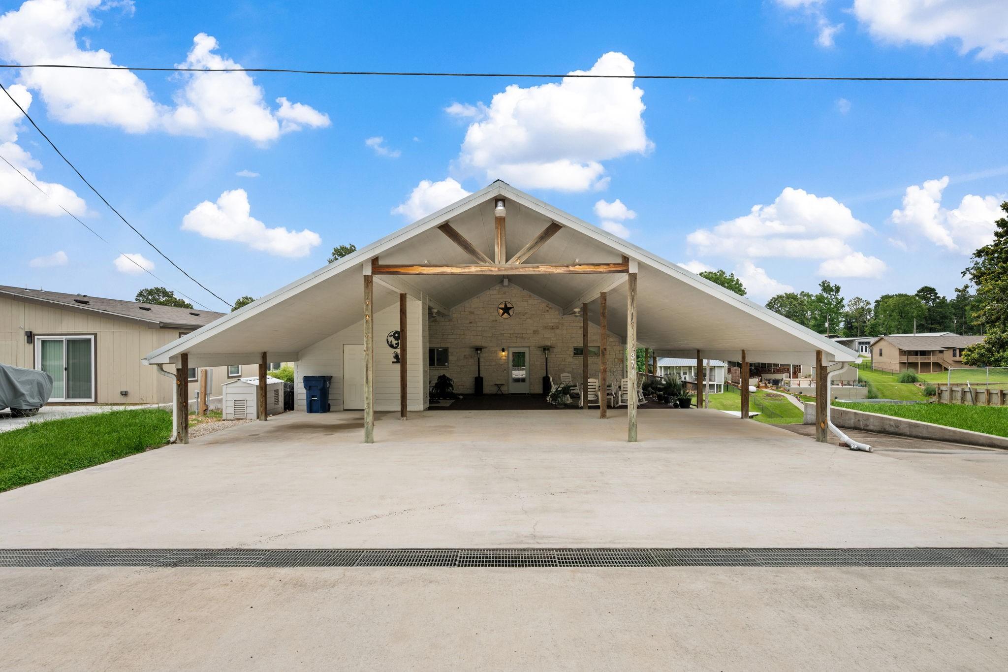Image 3: Front of home.  Could be 4 carports.  Two large se
