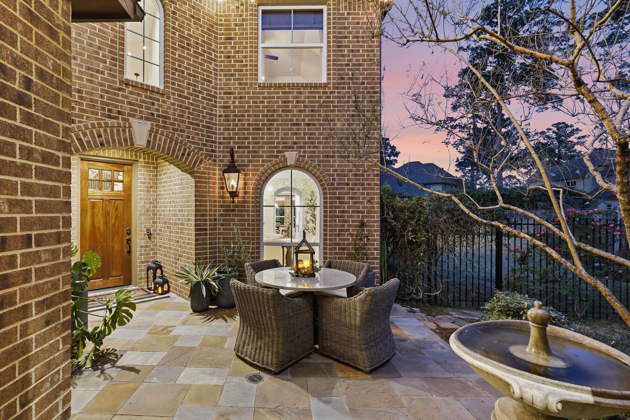 Image 4: Twilight view of the home&rsquo;s private courtyard show