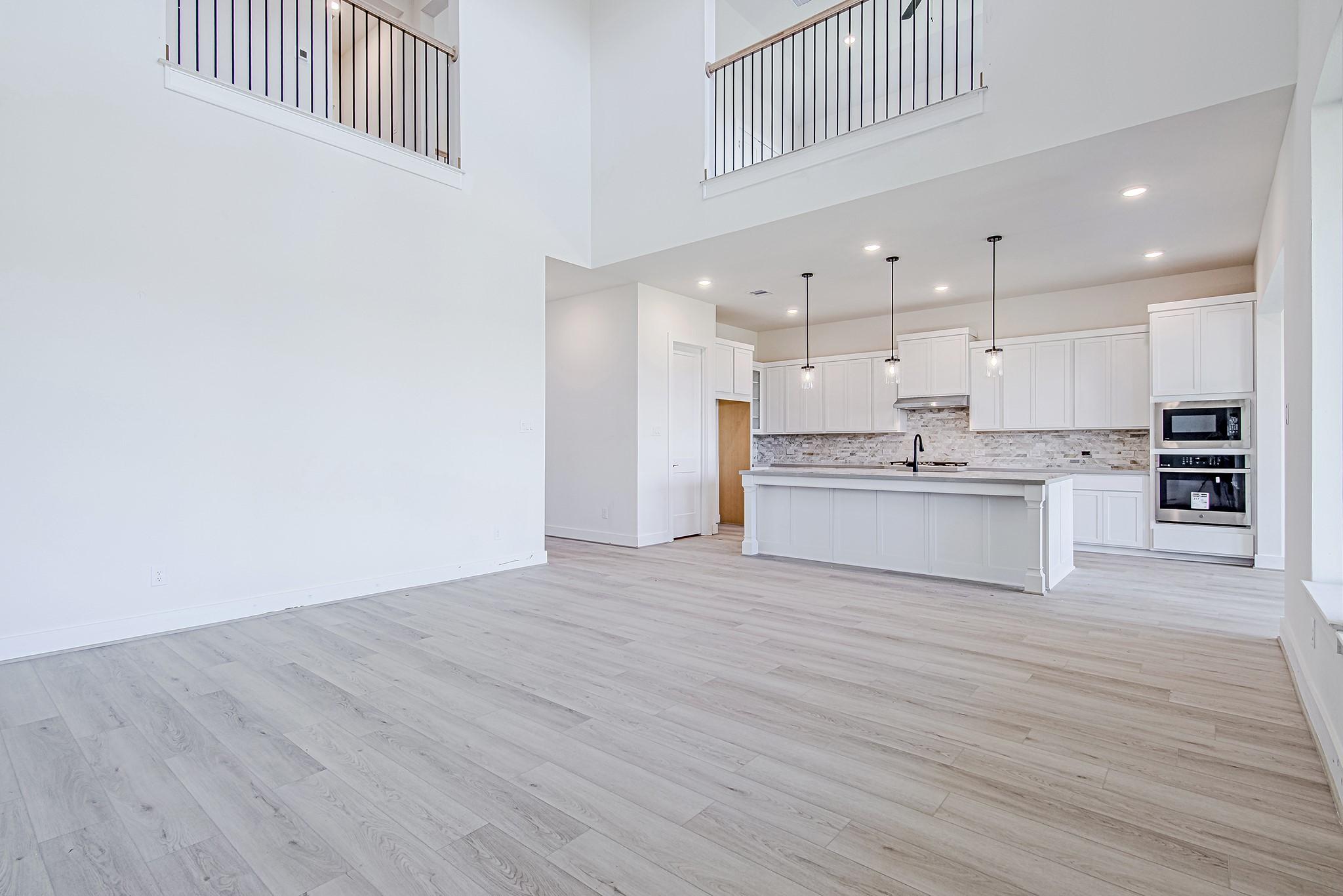 Image 3: Step inside to a soaring two-story entry that sets