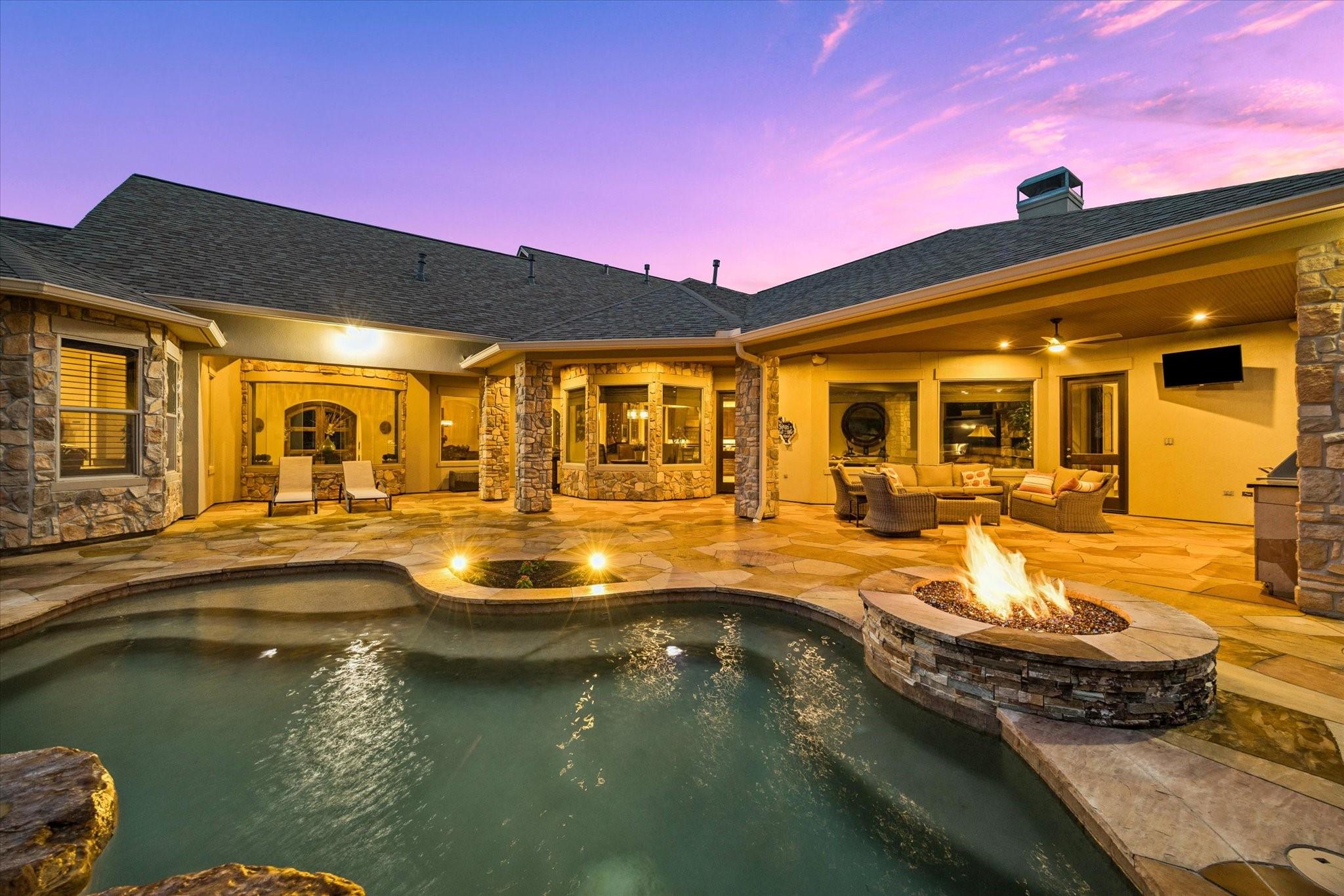 Image 2: The sparkling heated spa pool, fire feature, and e