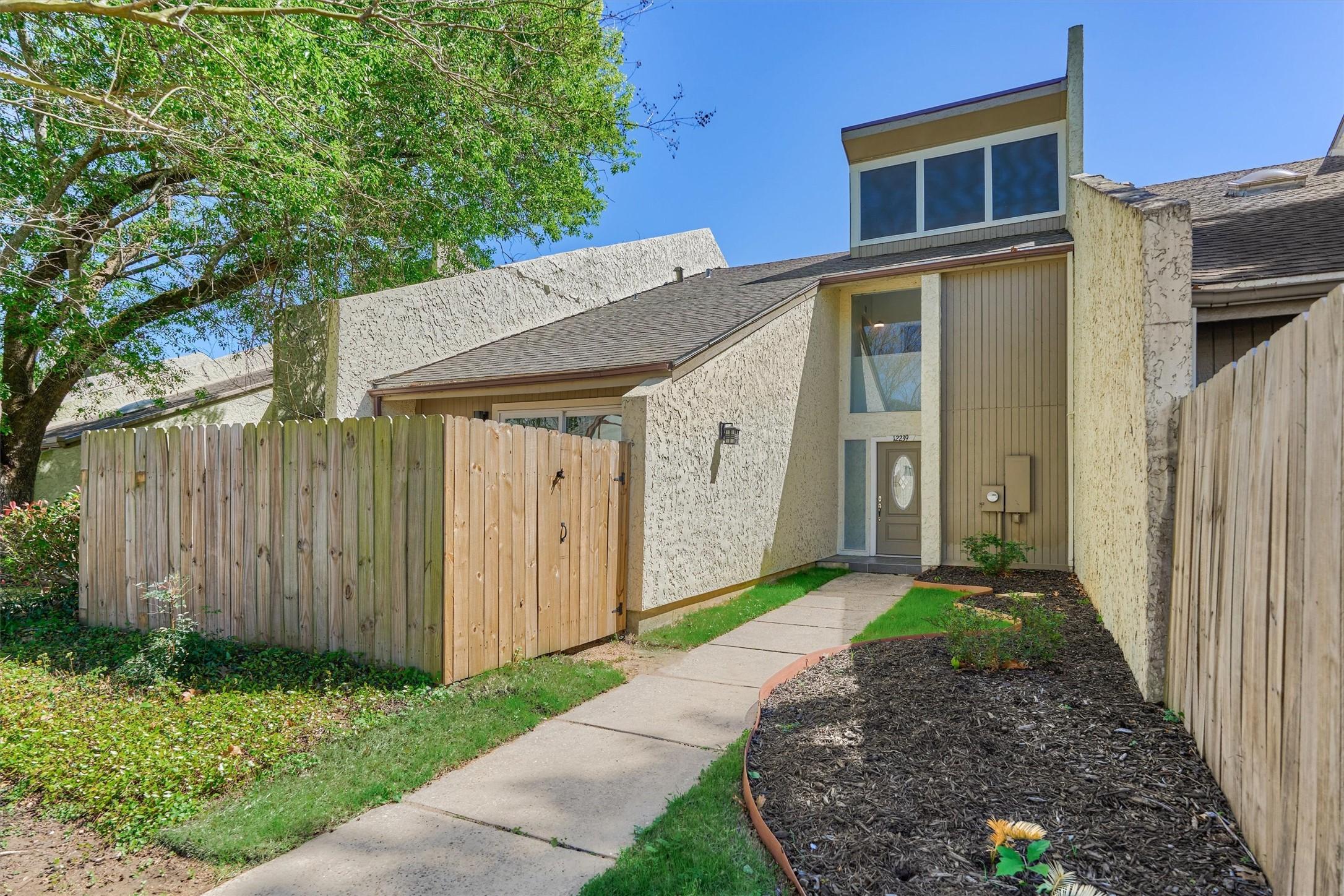 Image 2: The townhome has 2 parking spaces in front plus ad