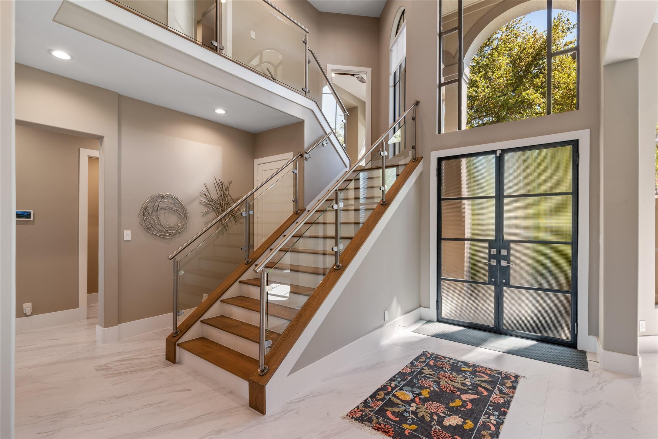 Image 4: Stunning glass-railed staircase creates a dramatic