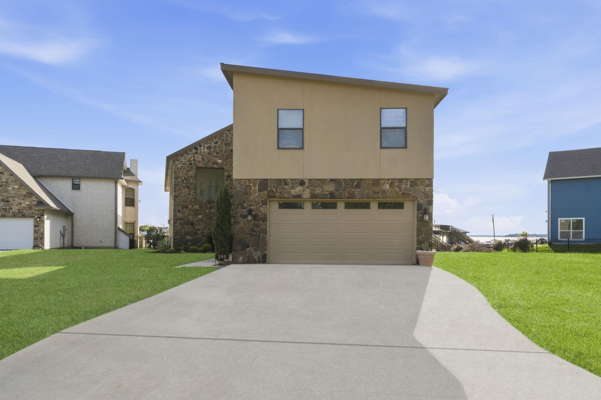Image 2: front driveway and garage the home's front door is