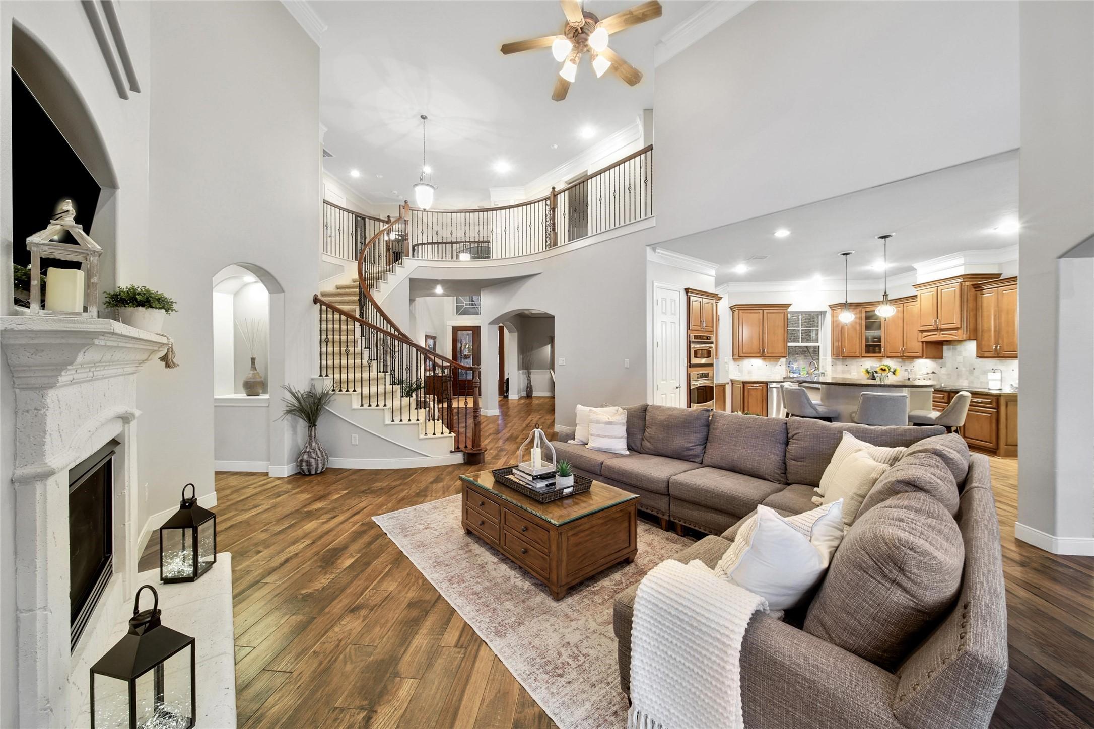 Image 2: Elegant living area with high ceilings, a cozy fir