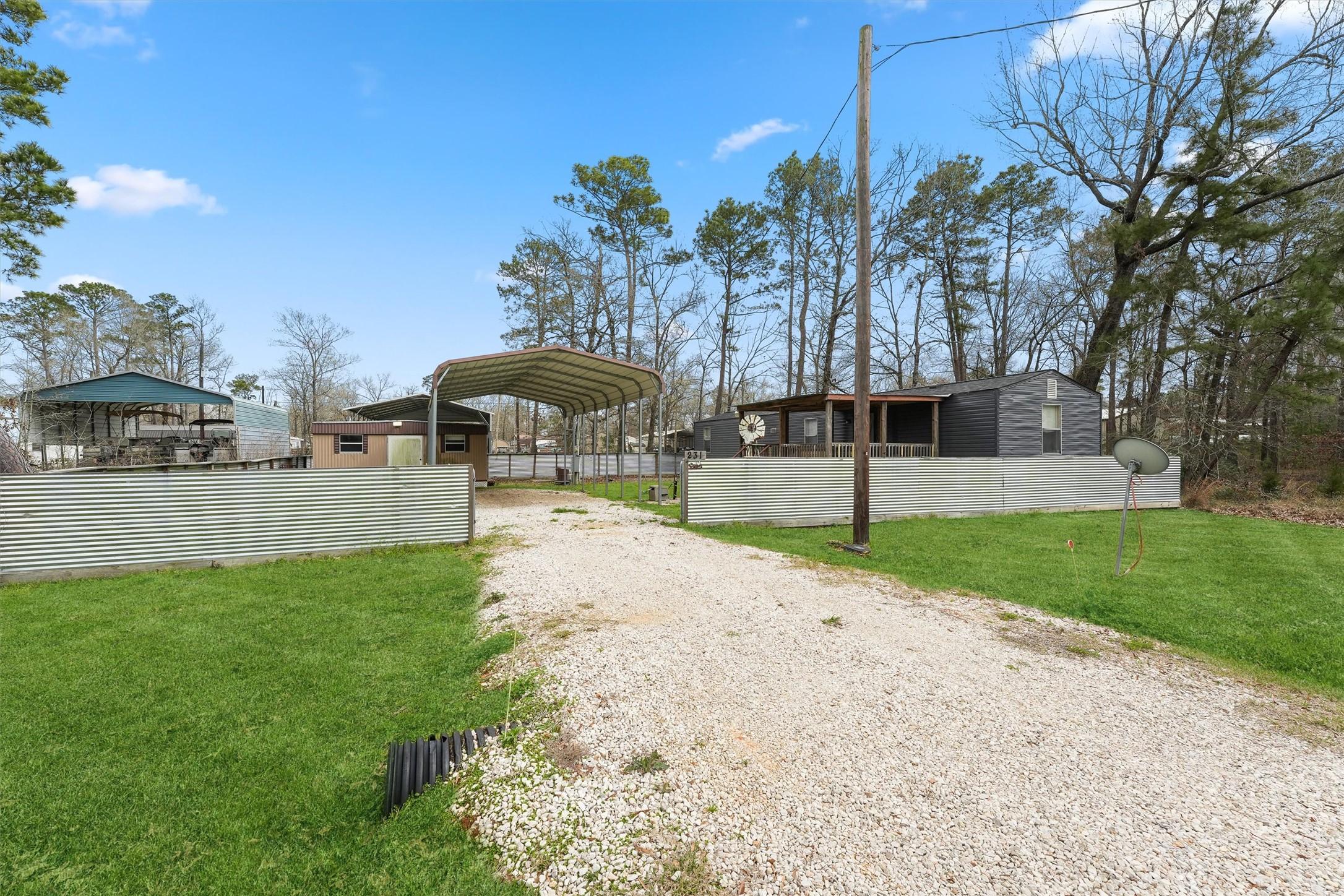 Image 1: Double lot with full RV hookup under carport; encl