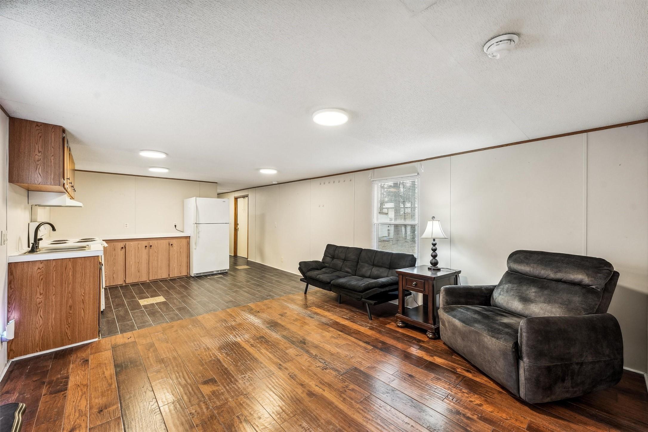 Image 4: Open concept living/dining; furniture remains with