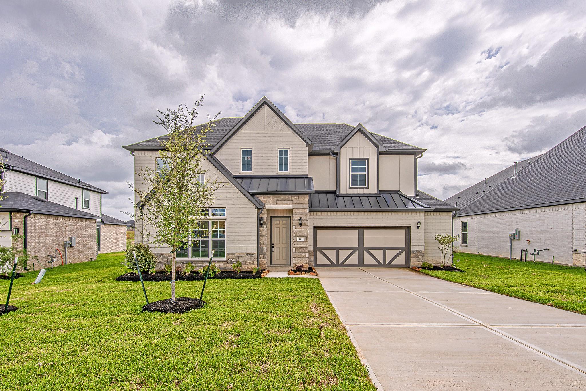 Image 1: Beautiful two-story home with a spacious driveway,
