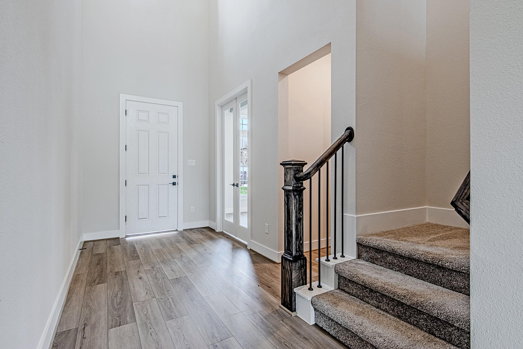 Image 2: Welcoming entryway featuring wood-look flooring an