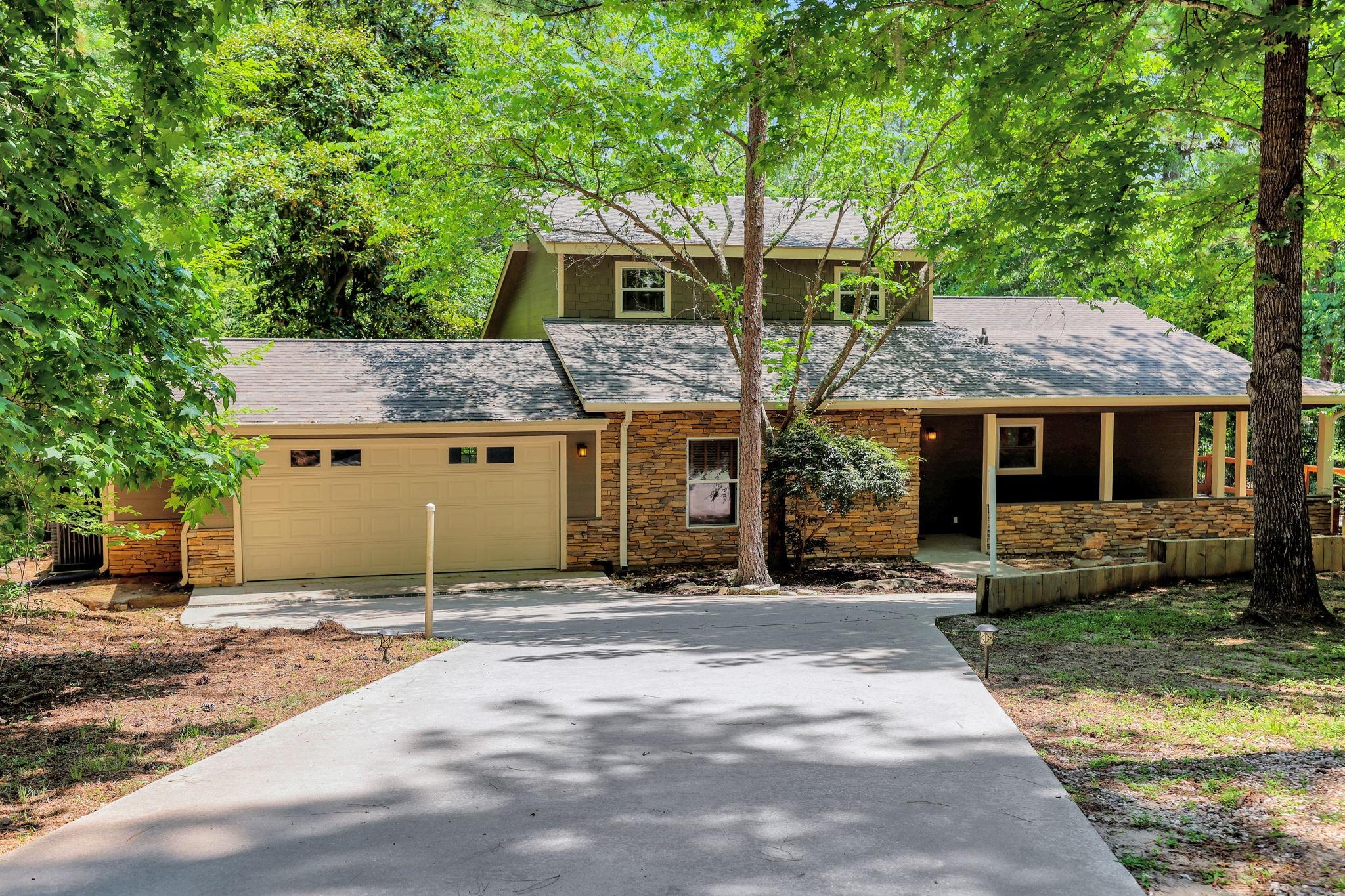 Image 2: This home is nestled amongst the trees on three sp