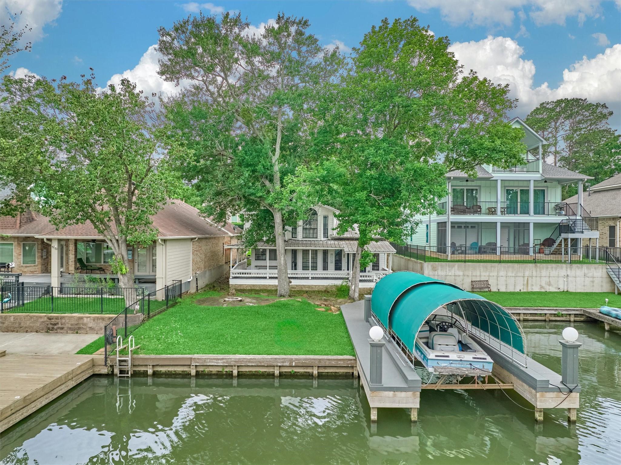 Image 1: The back view of the home shows the new boat dock