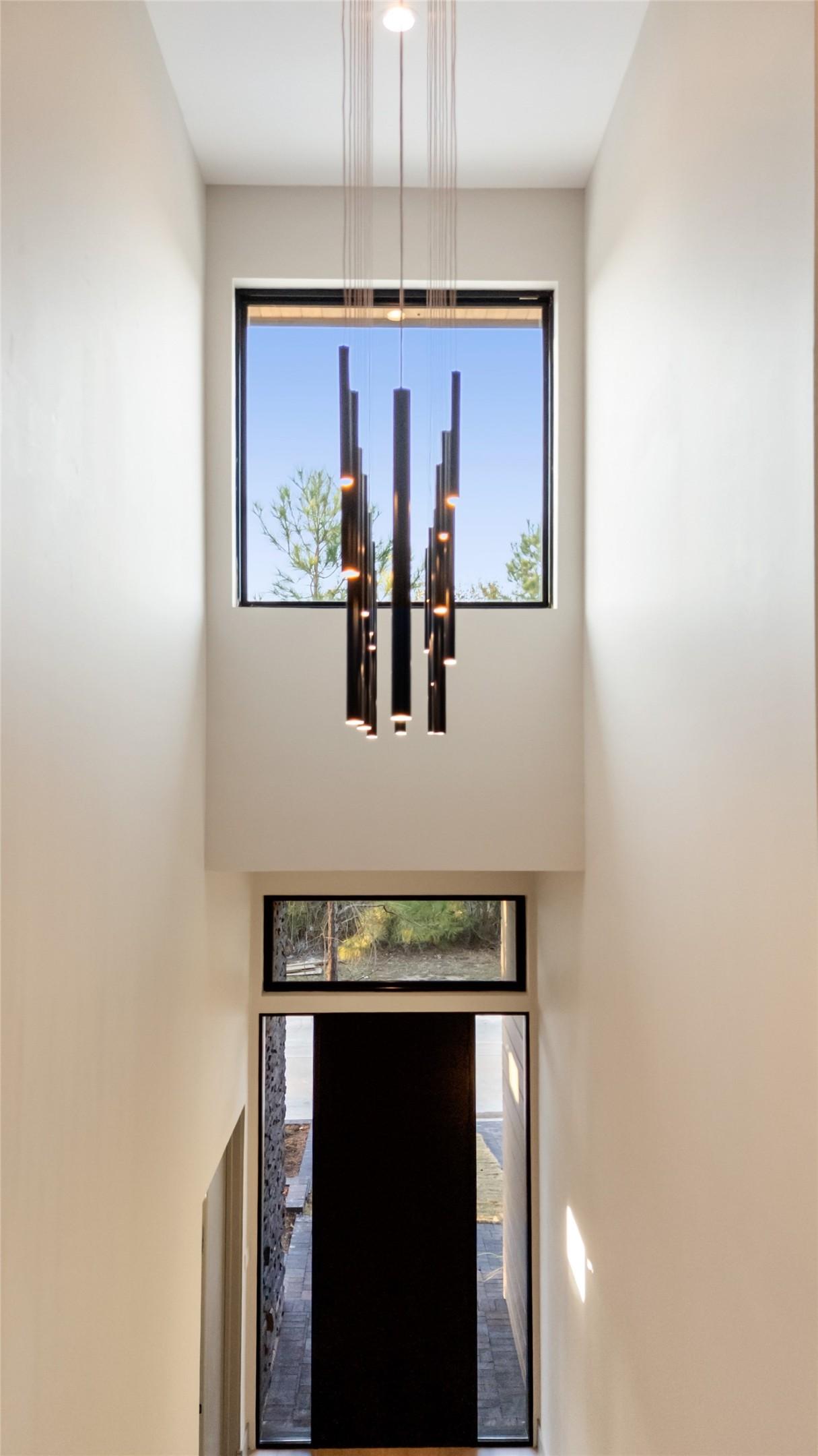 Image 2: The photo showcases a modern entryway with high ce