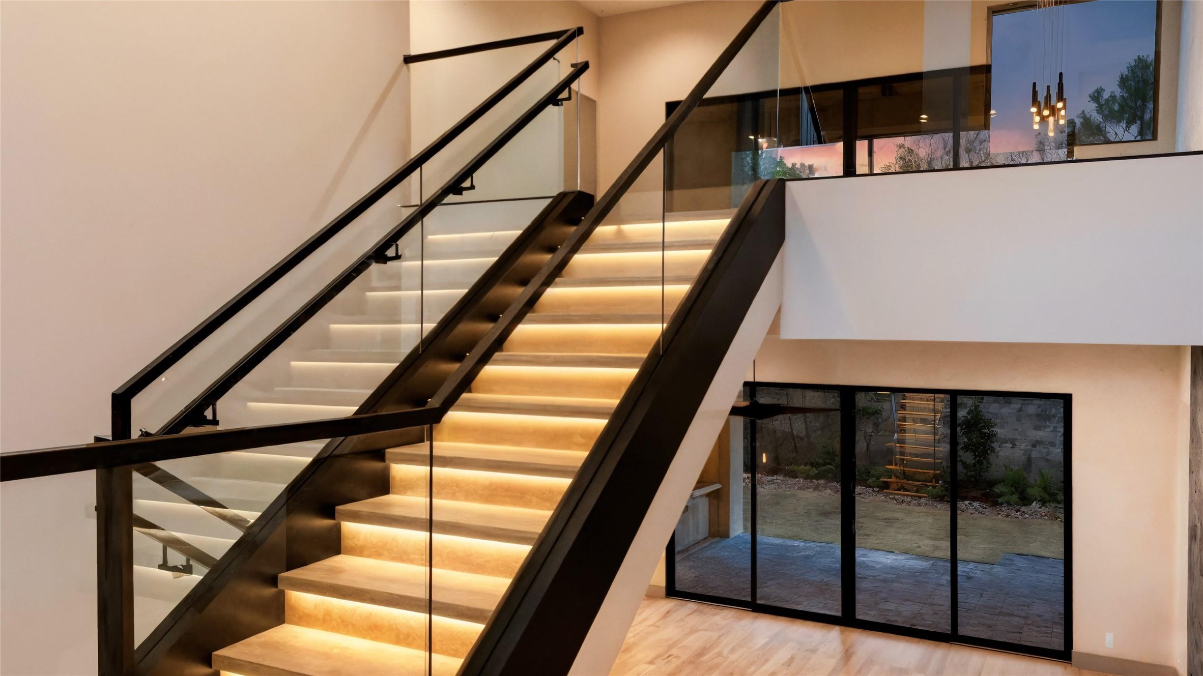 Image 3: This home features a modern staircase with sleek g