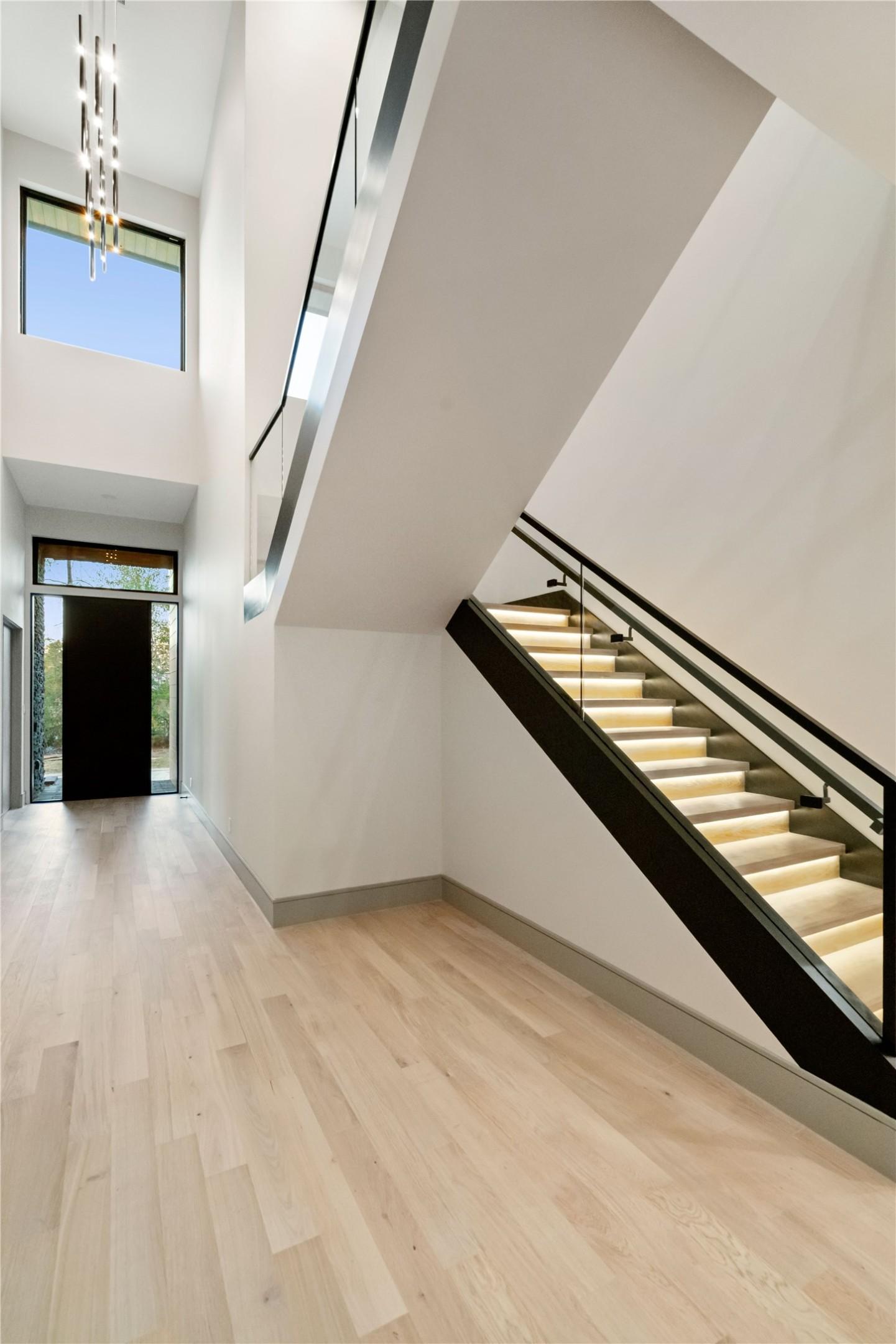 Image 4: This modern entryway features high ceilings, a sle