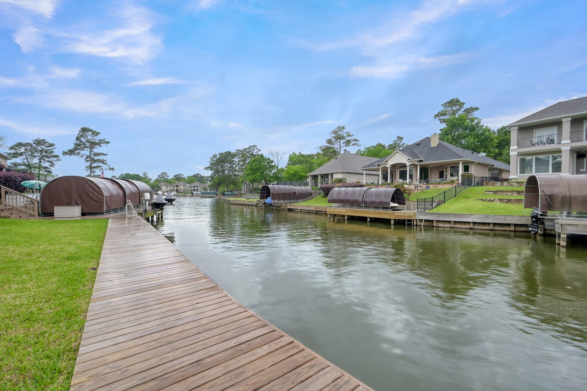 Image 2: Scenic canal leading to Lake Conroe with stunning