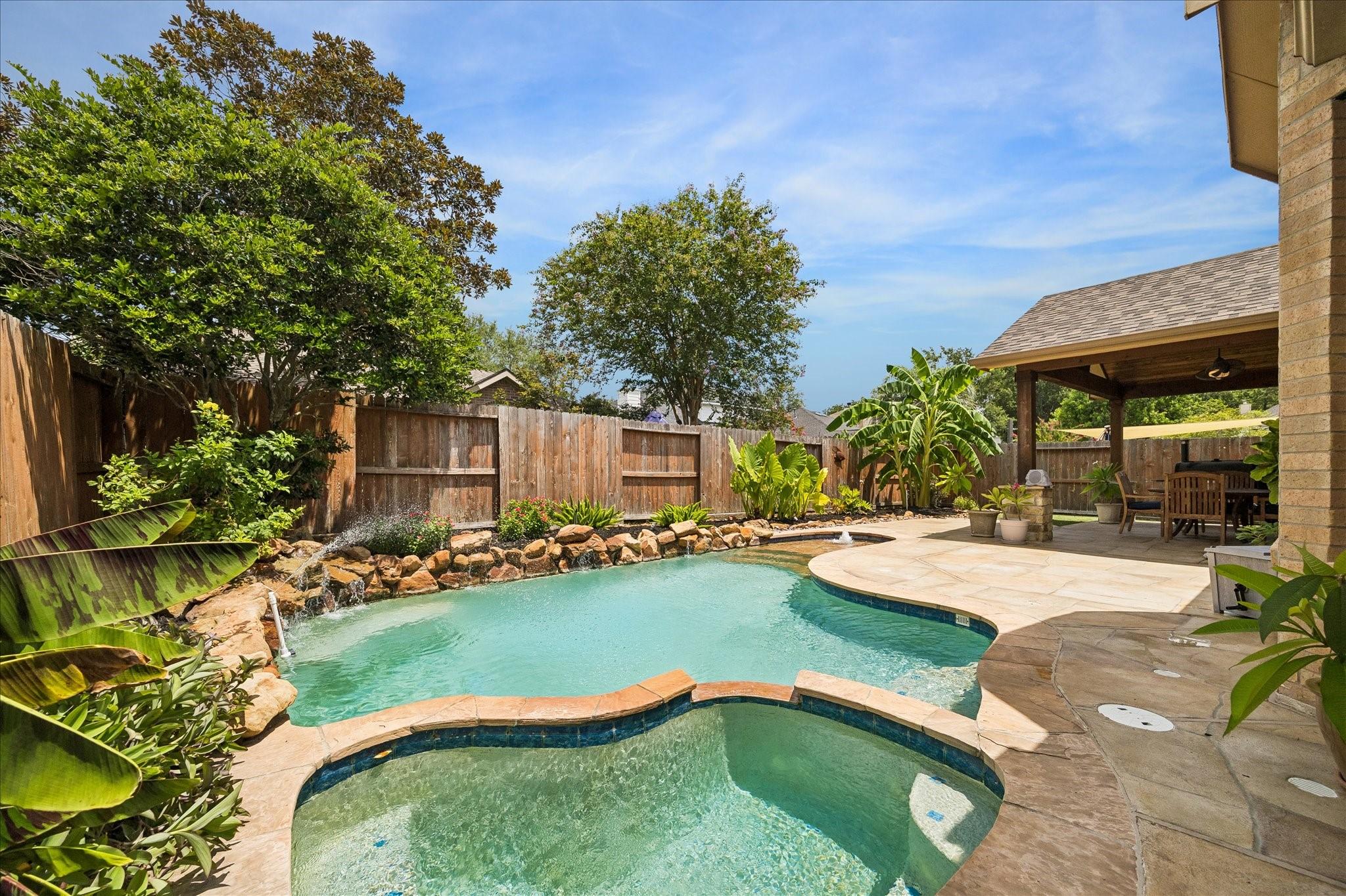 Image 4: You can relax in this backyard oasis in the heated