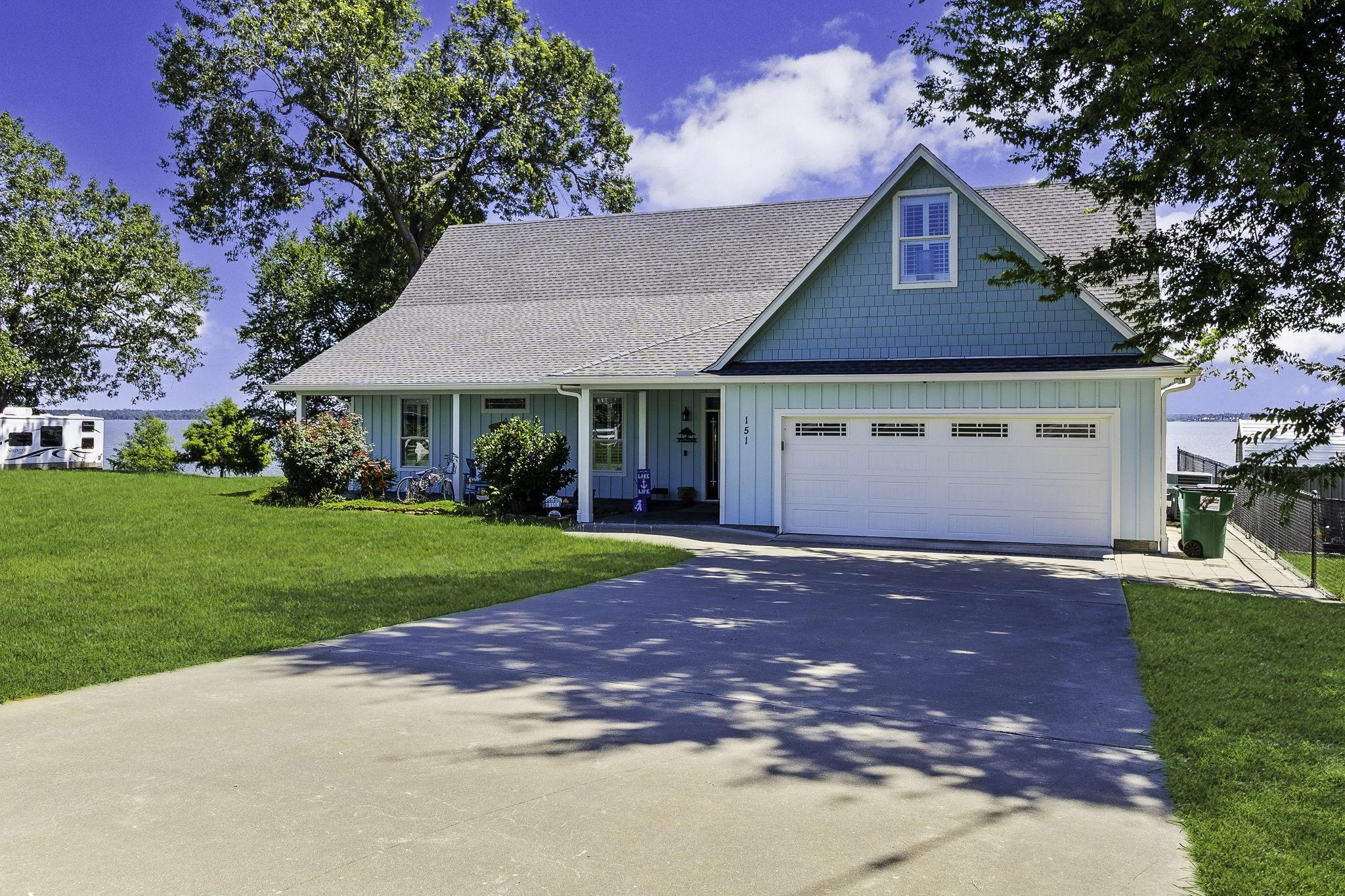 Image 2: Stunning lakefront home with a spacious driveway,
