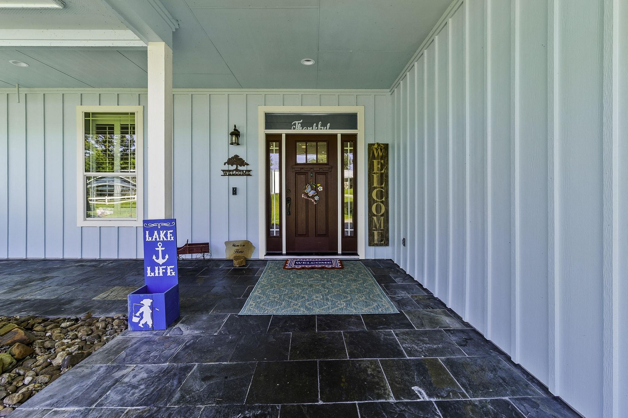 Image 4: Welcoming covered front porch with slate tile floo