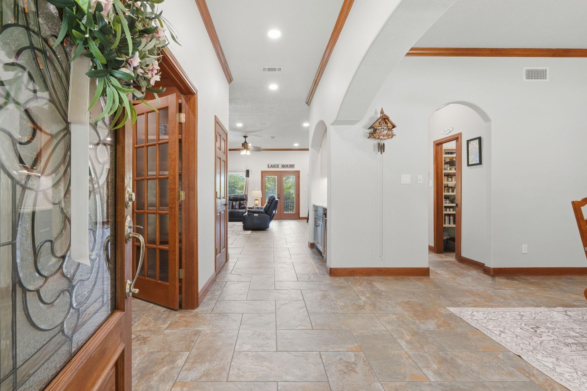 Image 4: Entrance with Direct View to Full Covered Patio.