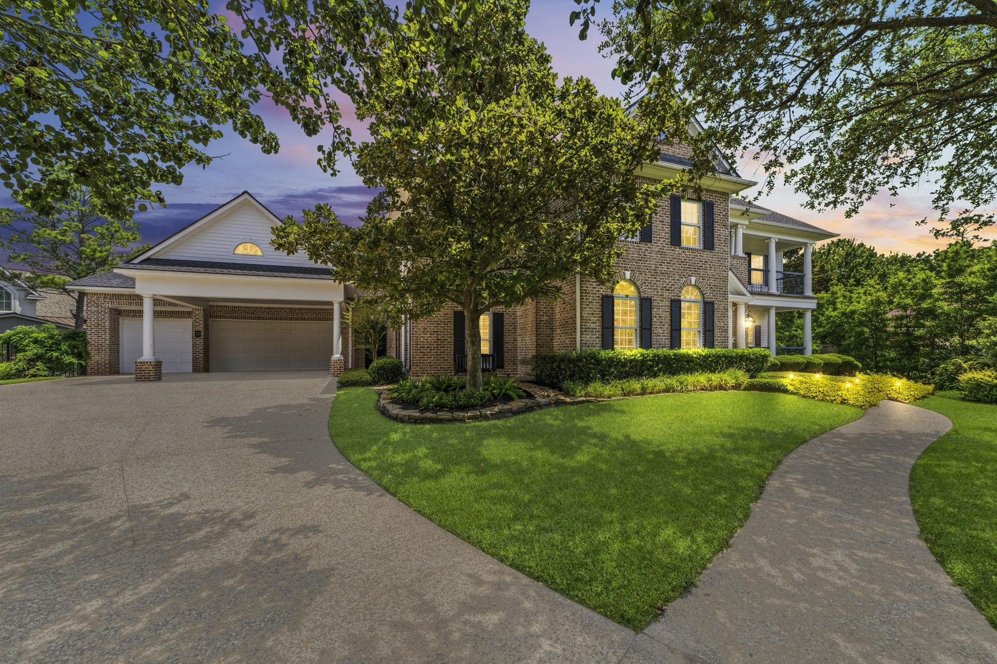 Image 4: Three-car garage with elegant brick construction,