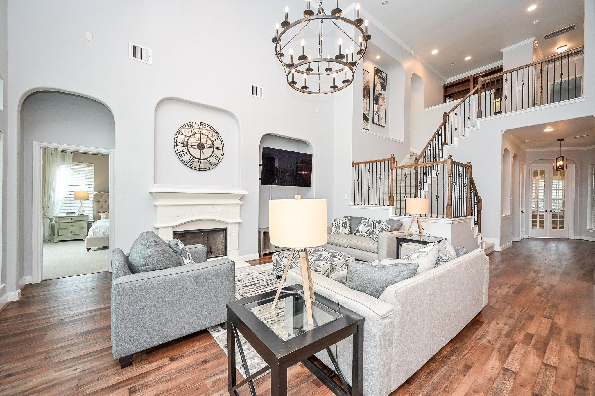 Image 1: Welcoming living room with high ceilings, large wi