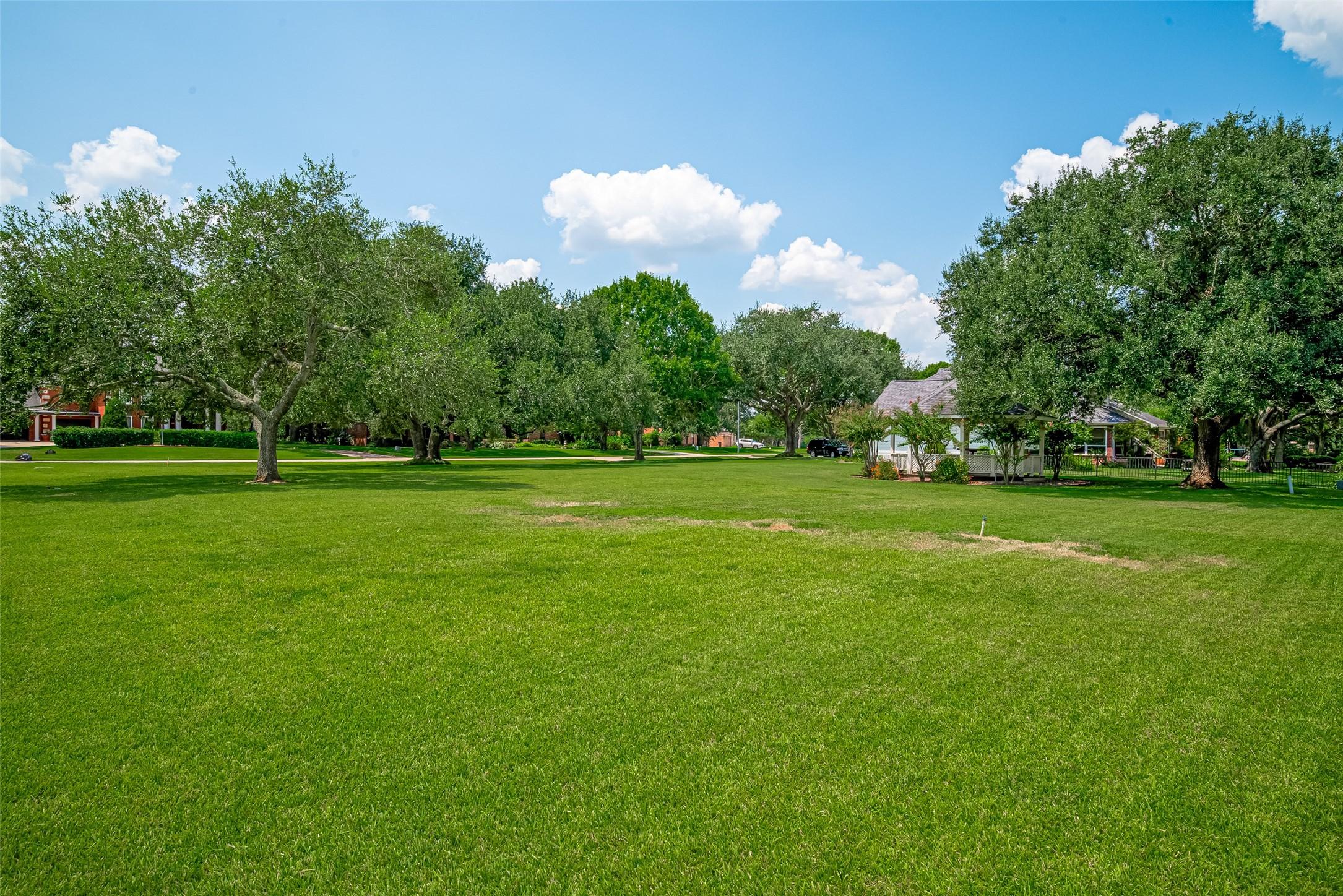 Image 4: Beautiful mature oak trees line the border of the