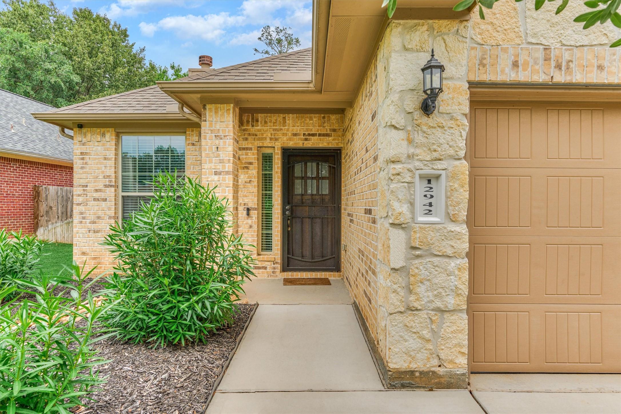 Image 4: Welcoming entryway w/ neutral brick and stonework