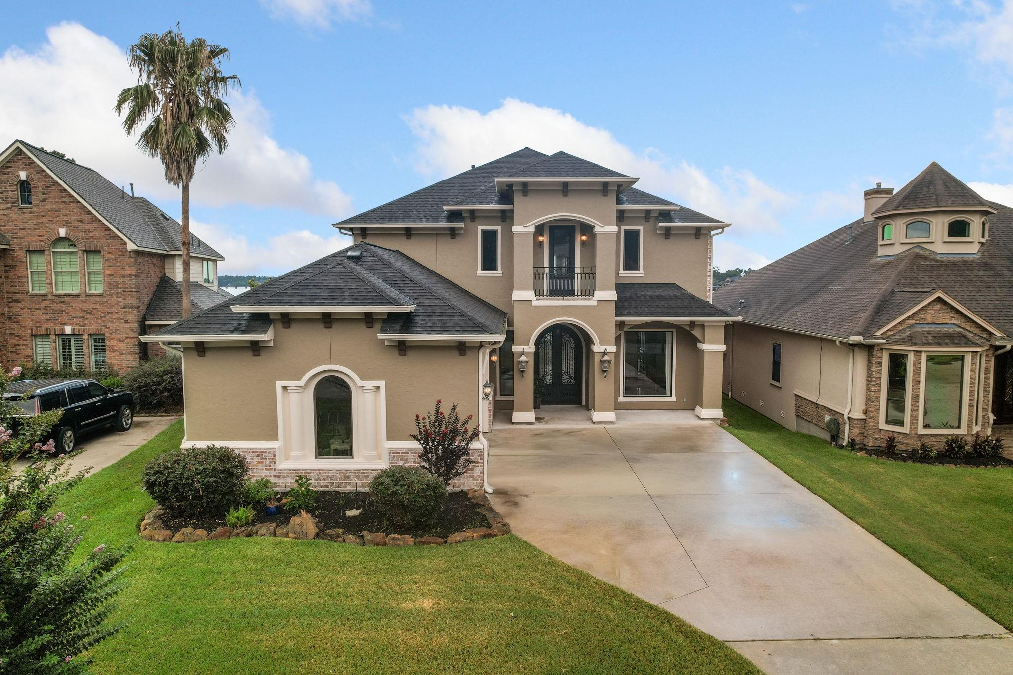 Image 2: Elegant stucco and brick exterior creates timeless