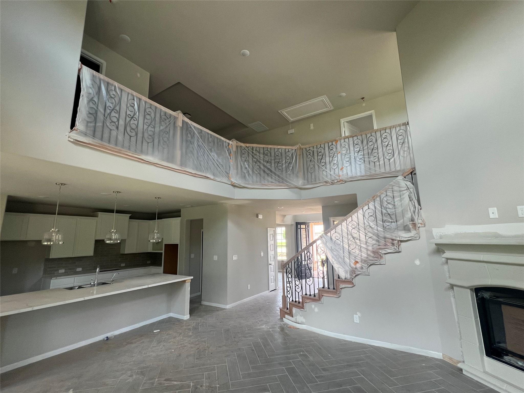 Image 4: Open great room with cozy fireplace - still under
