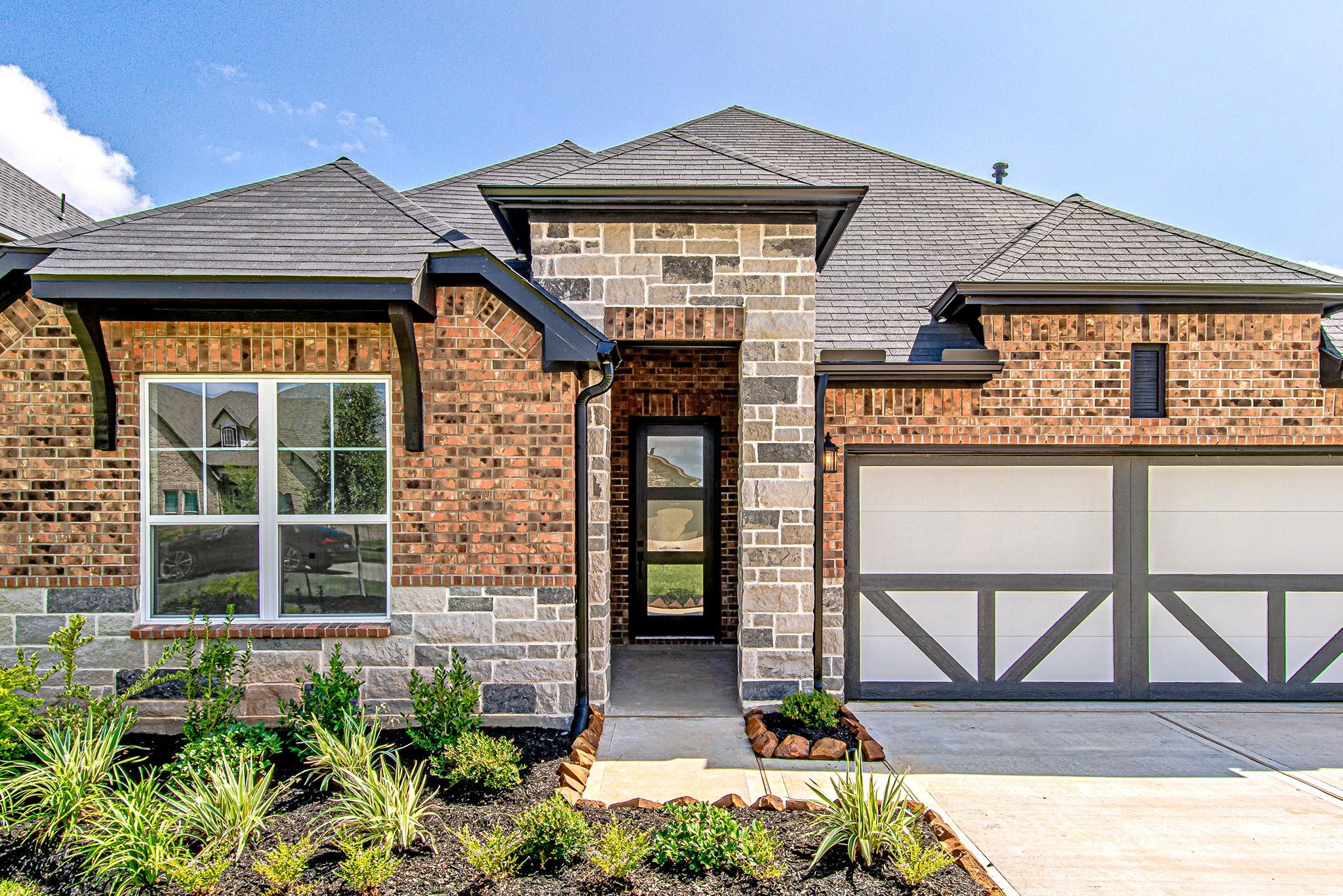 Image 2: A charming brick and stone exterior, inviting fron