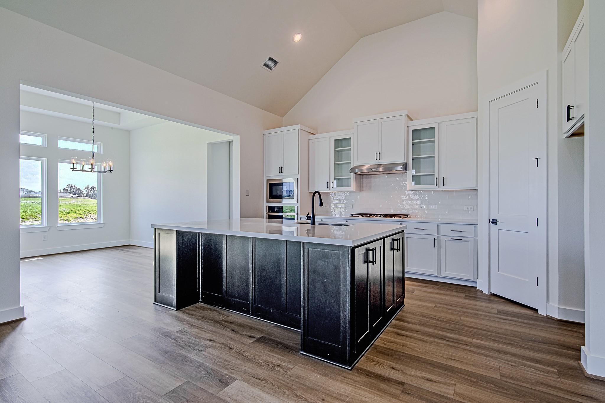 Image 4: The open-concept kitchen seamlessly connects to th