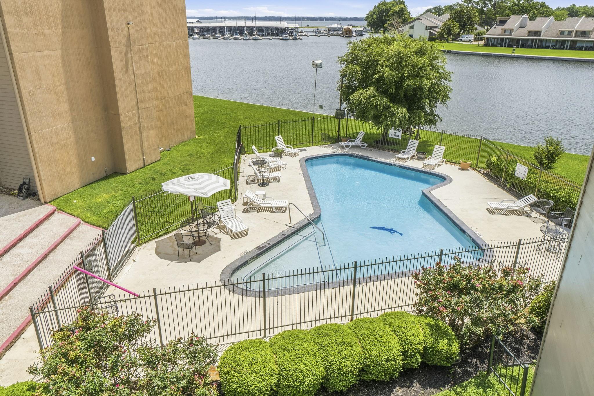 Image 1: Resort-style waterfront pool overlooking the tranq